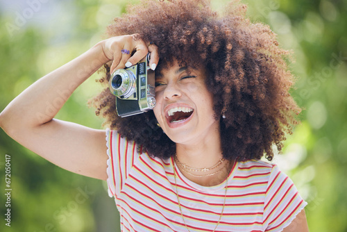 Nature, afro and black woman with photography camera taking happy picture memory with retro style. African hipster girl with smile in park using vintage photographer equipment to capture moment. photo