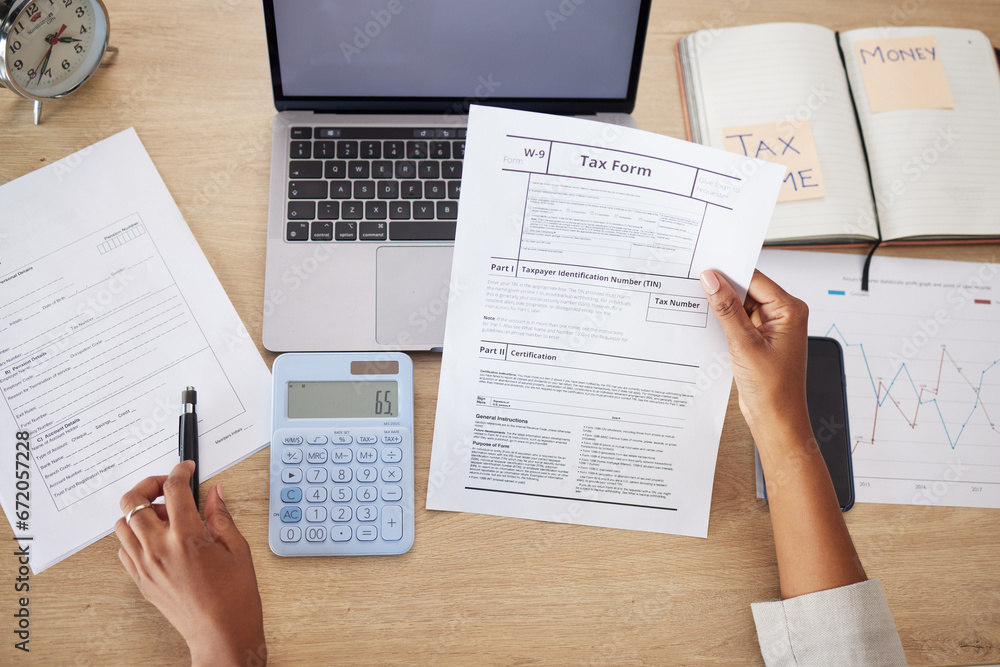 Obraz premium Taxes form, documents and business person for financial application, audit and time management on computer. Laptop, calculator and accountant or people hands for finance paperwork and accounting