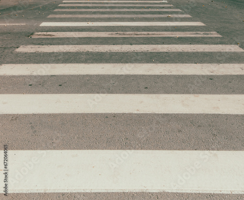 White stripes on a pedestrian crossing as a background. Texture