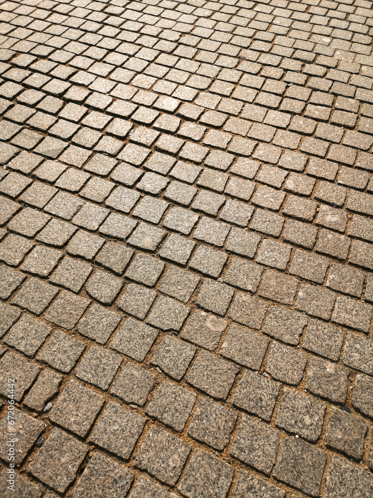 Paving stones on the road as an abstract background. Texture