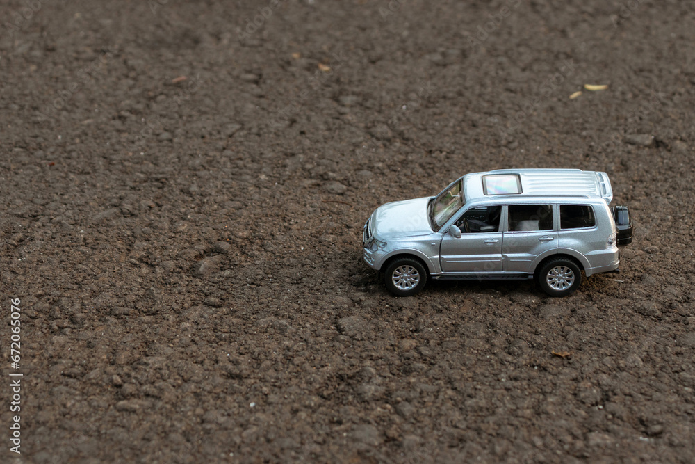 Concept for traveling and outdoor activities. Photo of a toy car on the road. After some edits. Concept for traveling and outdoor activities. Photo of a toy car on the road. After some edits.