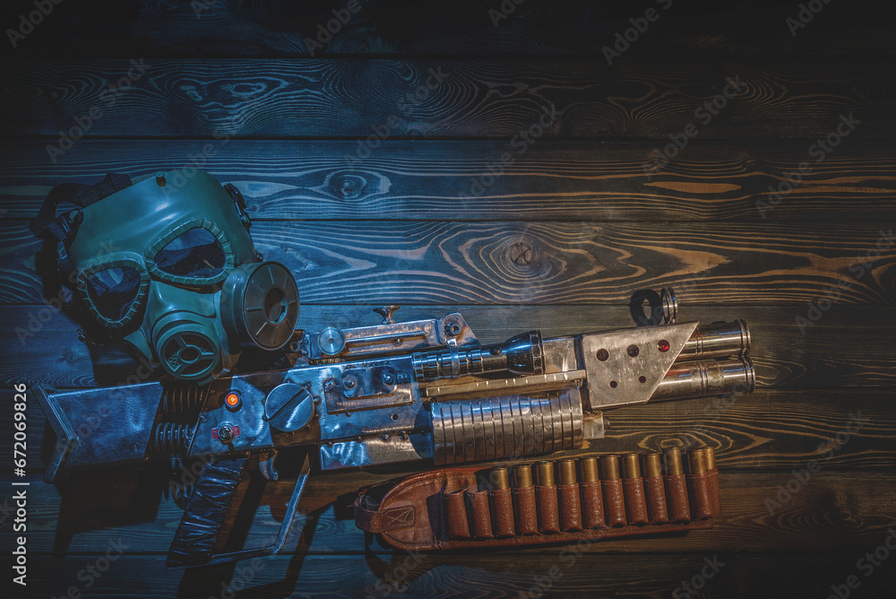 Sci fi post apocalypse pump shotgun and gas mask on the survivor table concept background. - obrazy, fototapety, plakaty 