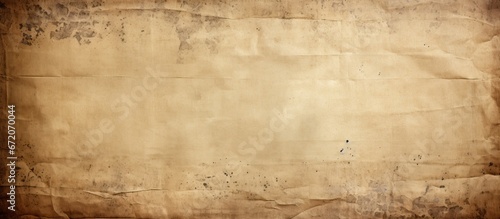 A vintage brown or beige retro design background made of old paper with a damaged and weathered dirty surface It has a rustic and grungy texture similar to a blank horizontal parchment page