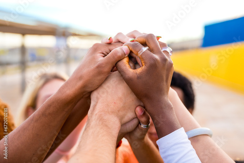 Hands of multi-ethnic people joining in the air