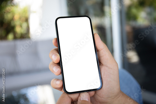 Male hands holding phone with screen isolated in office