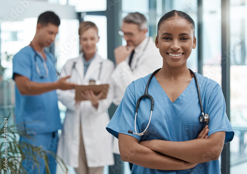 Doctor, portrait or black woman nurse with vision, motivation or leadership in hospital with team. Happy medical healthcare, wellness worker with smile at work for insurance or medicine in clinic