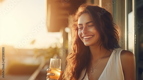 Blissful youthful lady clinks glasses with scrumptious cocktails with companion investing time together on enhanced porch on summer day near see.