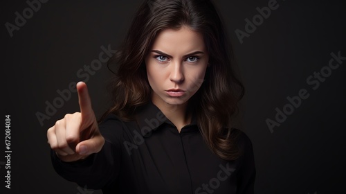 White lady indicating finger aside whereas posturing with shopping packs disconnected over ruddy foundation photo