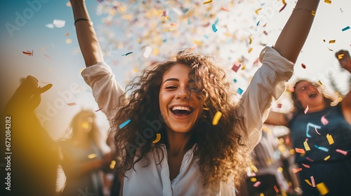 Upbeat dressed individuals celebrating at carnival party tossing confetti - Youthful companions having fun together at fest occasion - Youth, hangout, happy and joy concept photo