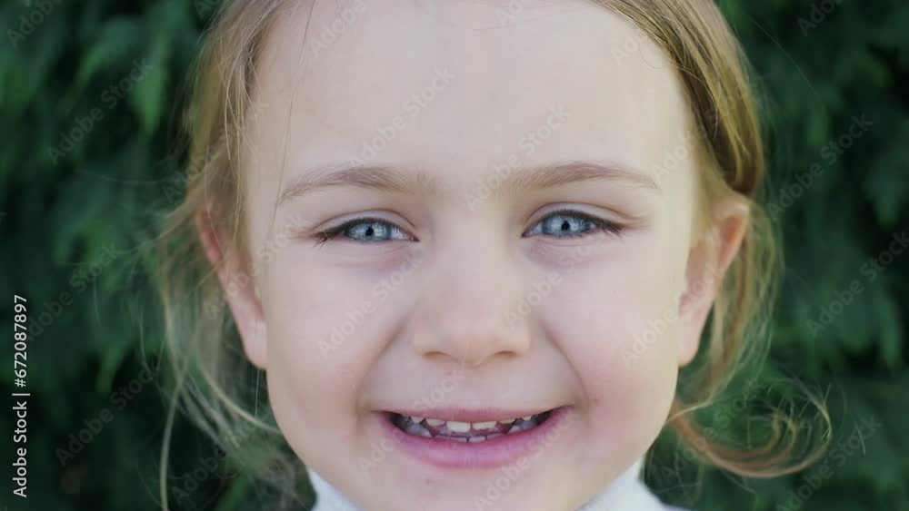 portrait of a smiling girl Happy little girl smiling in park close-up, enjoying life. Girl in nature, in park, outdoors. Smiling child concept of happy family, raising children portrait of a smiling girl Happy little girl smiling in park close-up, enjoying life. Girl in nature, in park, outdoors. Smiling child concept of happy family, raising children