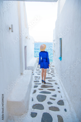 Woman in blue dress at the Streets of old town Mykonos during a vacation in Greece, Little Venice Mykonos Greece