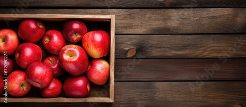 An aerial view of a wooden crate filled with newly harvested apples