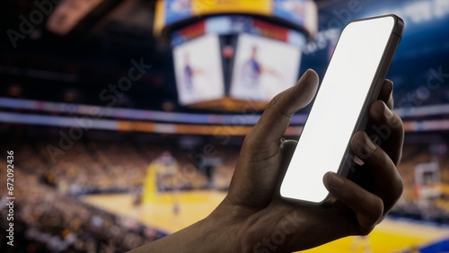 Canvas Print CU African-American Black male using phone during basketball game