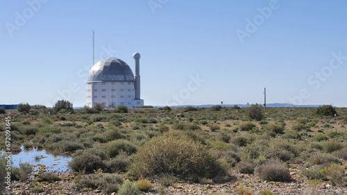 SALT telescope building on sunny day in Karoo scrub landscape photo