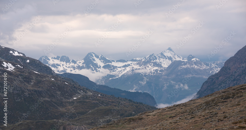 Panoramic view of high snowy mountains in Switzerland. Swiss alps