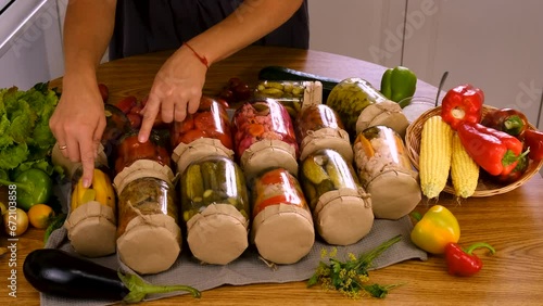 A woman is preserving vegetables in the kitchen. Selective focus. photo