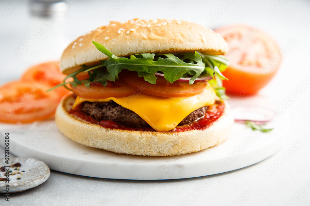 Traditional homemade cheeseburger with arugula Traditional homemade cheeseburger with arugula
