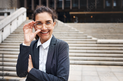 Portrait, business and woman in a city, glasses and happiness with travel, success or corporate. Face, female person or lawyer outdoor, eyewear or smile with clear vision, empowerment or professional