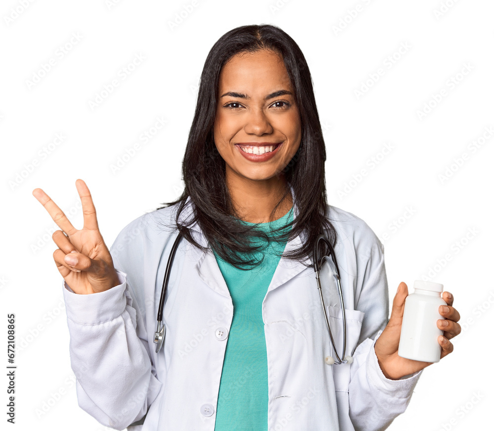 Young Filipina doctor holding a pill bottle showing number two with fingers. Young Filipina doctor holding a pill bottle showing number two with fingers.
