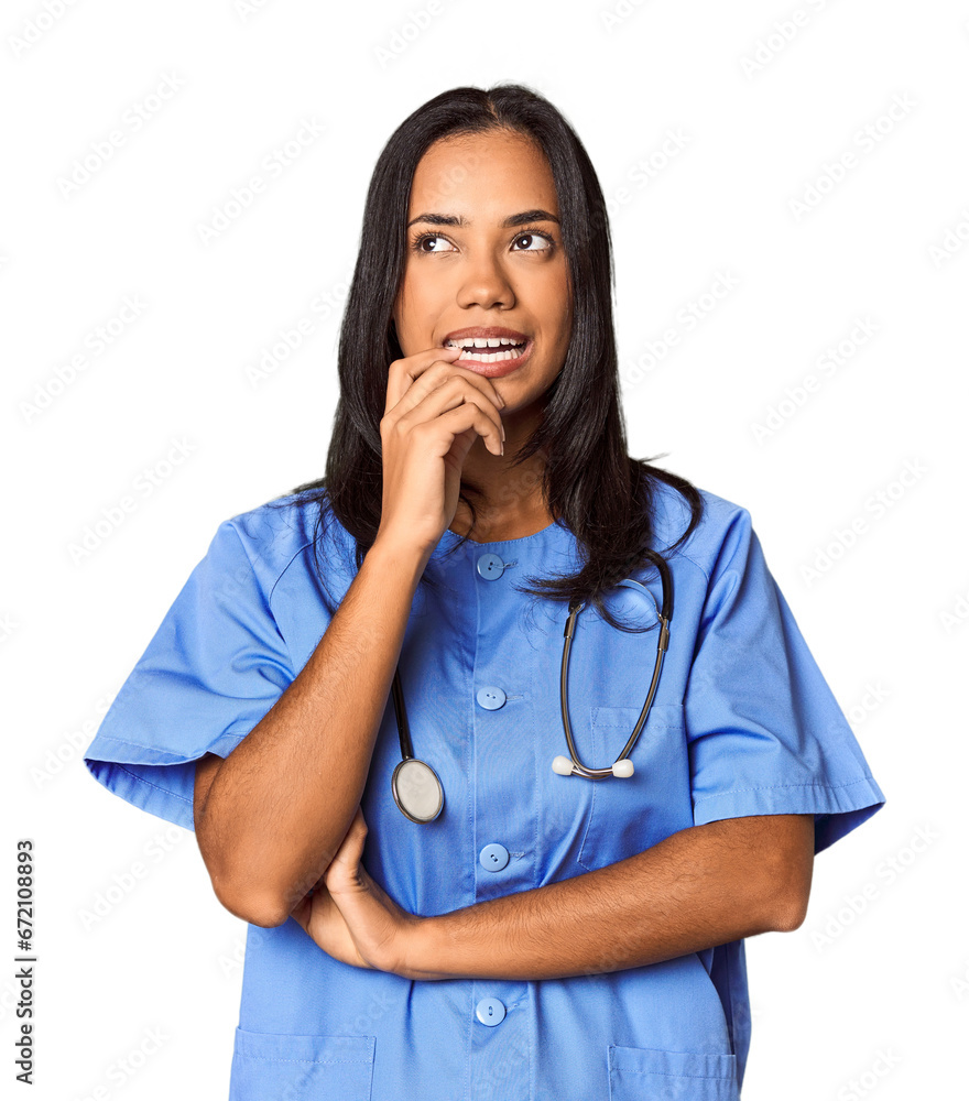 Young Filipina nurse posed in studio relaxed thinking about something looking at a copy space. Young Filipina nurse posed in studio relaxed thinking about something looking at a copy space.