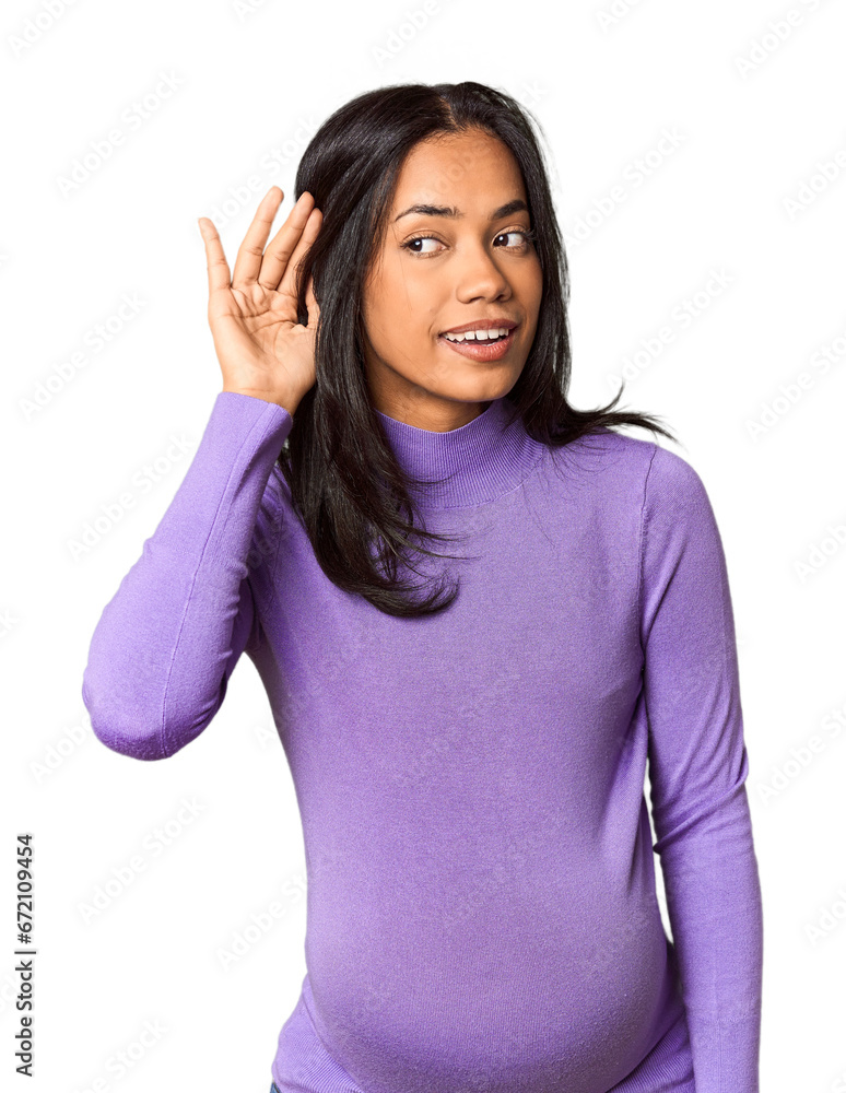 Young Filipina woman expecting a baby in studio trying to listening a gossip. Young Filipina woman expecting a baby in studio trying to listening a gossip.