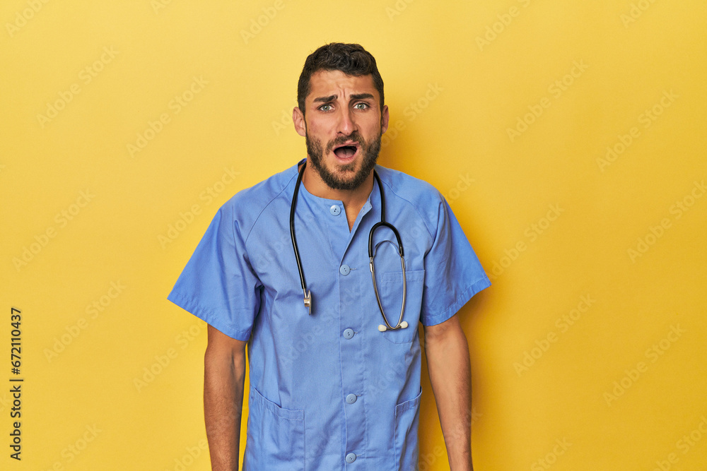 Young Hispanic male nurse Young Hispanic male nurse poses confidently screaming very angry and aggressive.< mixto > Young Hispanic male nurse Young Hispanic male nurse poses confidently screaming very angry and aggressive.< mixto >