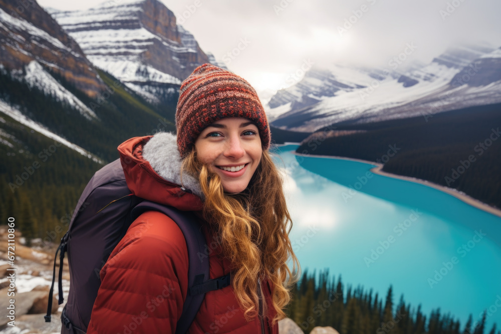 Happy smiling girl, with a backpack and jacket relaxing in the winter nature. Peyto Lake, Alberta Happy smiling girl, with a backpack and jacket relaxing in the winter nature. Peyto Lake, Alberta