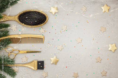 Horizontal banner with golden hairdressing tools and numbers 2024. Winter holiday flatlay with hair salon accessories, Christmas tree branches, garland, stars. Idea for congratulations.