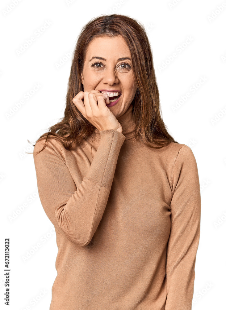 Middle-aged woman portrait in studio setting biting fingernails, nervous and very anxious. Middle-aged woman portrait in studio setting biting fingernails, nervous and very anxious.