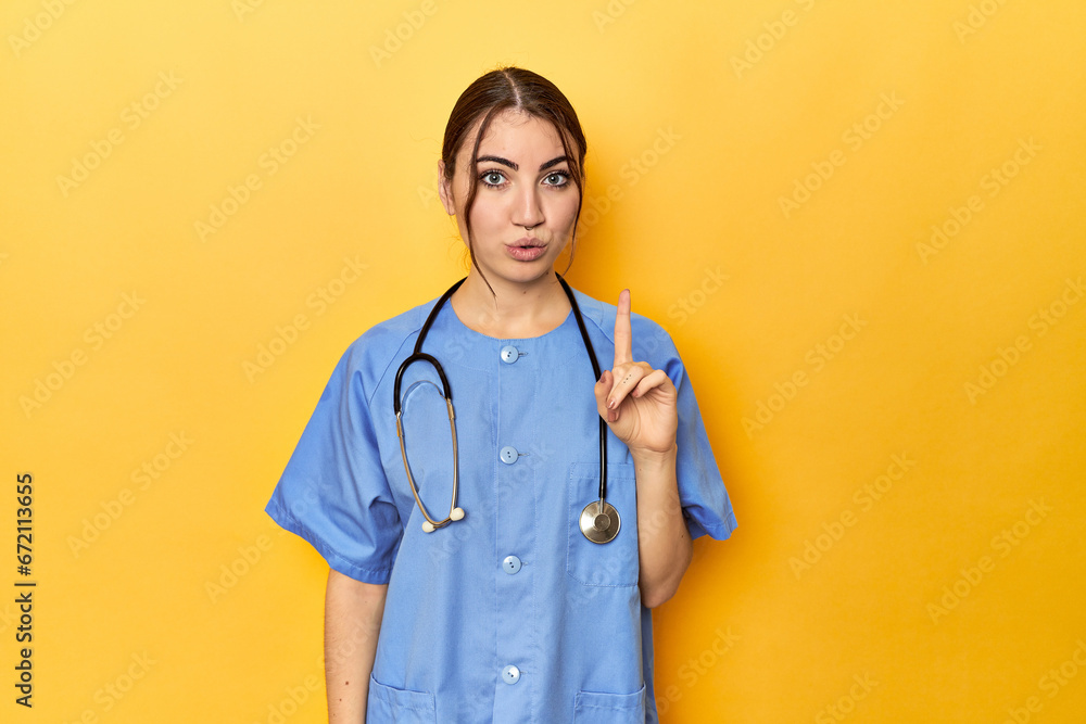 Young nurse in a yellow studio having some great idea, concept of creativity. Young nurse in a yellow studio having some great idea, concept of creativity.