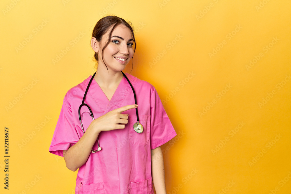 Nursing assistant in yellow background smiling and pointing aside, showing something at blank space. Nursing assistant in yellow background smiling and pointing aside, showing something at blank space.