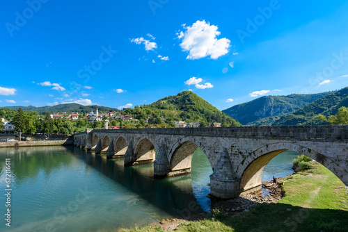 Visegrad, Bosnia and Herzegovina - August 13, 2023: Famous bridge on the Drina in Visegrad, Bosnia and Herzegovina. Mehmed Pasa Sokolovic Bridge on Drina River photo