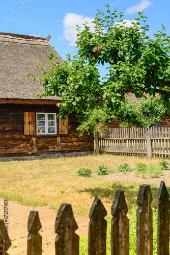 Small cozy houses. Wooden ancient buildings. Summer village and vacation. Farm bio products.
