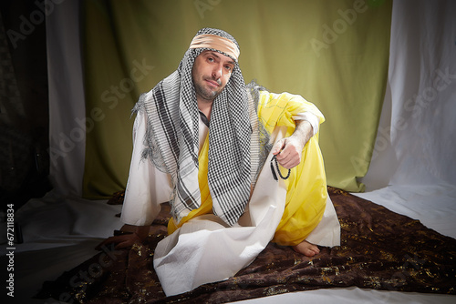 An imposing man in stylized eastern attire, a Sheikh or Sultan in Israel, Palestine, and Iran. Photoshoot with a male model photo