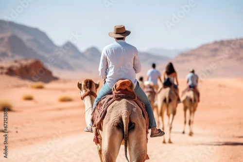 person riding camel in the desert © Denis