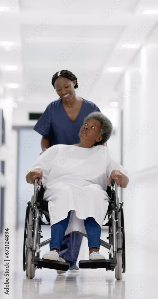 Vertical video of senior african american woman and female doctor, slow motion, copy space Vertical video of senior african american woman and female doctor, slow motion, copy space