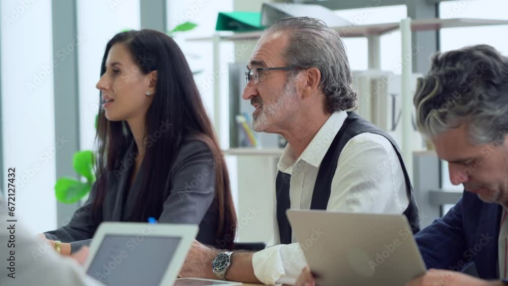 serious senior manager man and business woman sitting in meeting table talking or debate to colleagues in office . leader listen and answer questions coworker asking serious senior manager man and business woman sitting in meeting table talking or debate to colleagues in office . leader listen and answer questions coworker asking