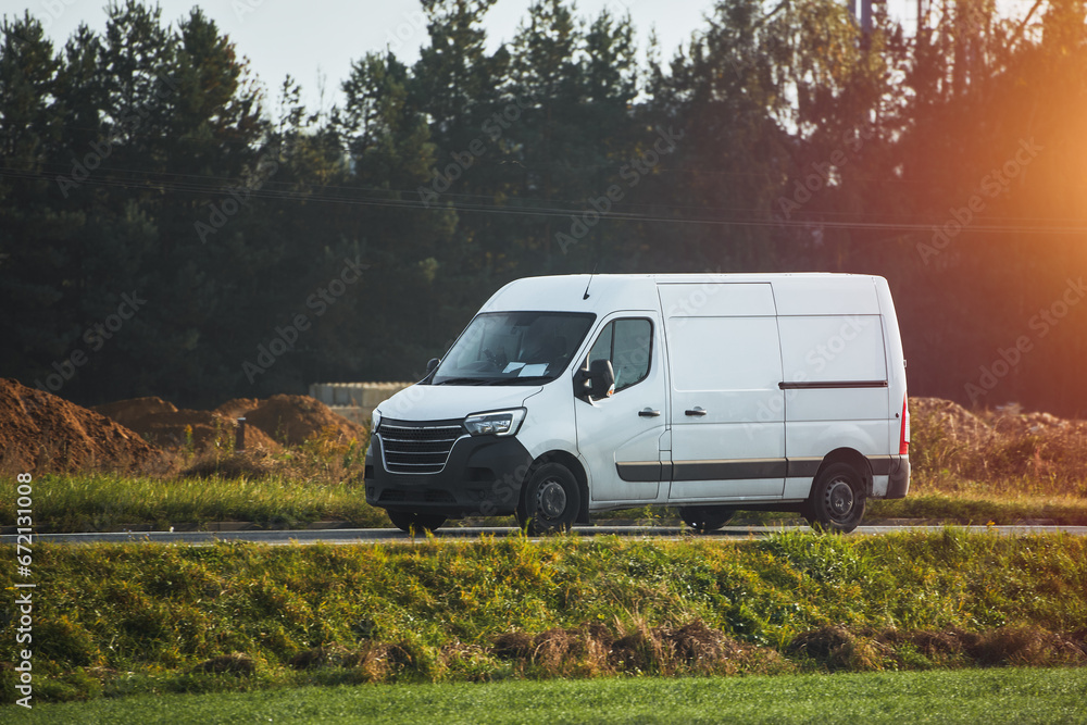 On the Delivery Route. Commercial Van Close-Up on the Road. Logistics branding. Commercial van on the road. Final destination shipping truck mock-up.