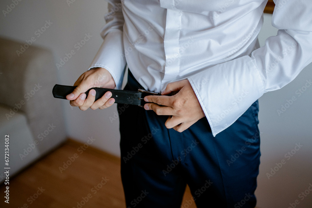 A young businessman is getting dressed
for a meeting. The beginning of a new working week.
A young businessman is getting dressed
for a meeting. The beginning of a new working week.