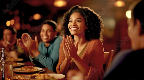 BEAUTIFUL AFRICAN AMERICAN WOMAN APPLAUDING AT A TABLE IN A RESTAURANT. legal AI