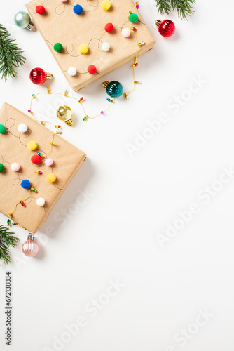 Christmas vertical banner with gift boxes decorated colorful balls, made by children on white background.