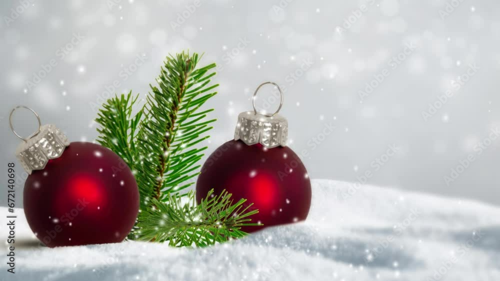 two red christmas balls in white deep snow with snowflake animation and blurred discreet background bokeh lights lights, winter nature backdrop with happy new year or merry christmas decoration two red christmas balls in white deep snow with snowflake animation and blurred discreet background bokeh lights lights, winter nature backdrop with happy new year or merry christmas decoration