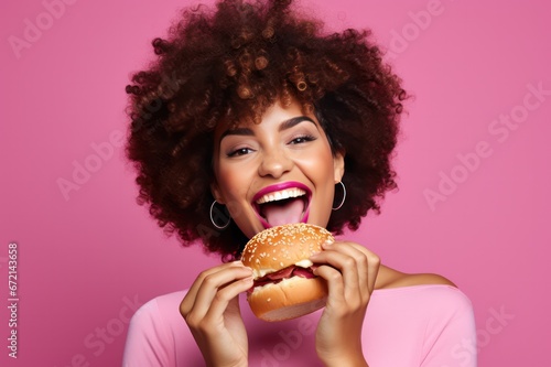 diverse woman eating a vegan burger on pink background. Restaurant, food delivery website banner.