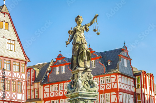 Frankfurt, Germany – Romerberg square, and fountain of justice in historical downtown with old timber houses during colorful sunset, cityscape photo