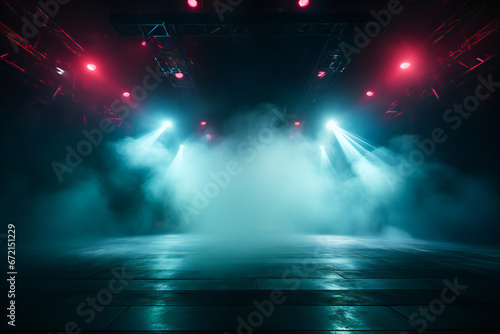 An empty stage ready for concert, with big colored lights and smoke