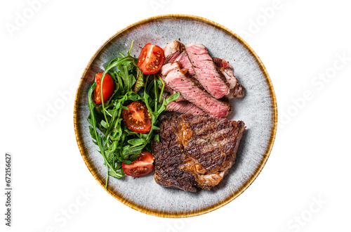BBQ Grilled rib eye steak, fried rib-eye beef meat on a plate with green salad.  Transparent background. Isolated