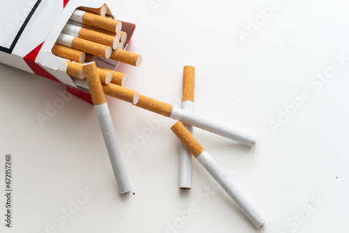 cigarette gun over white background photo