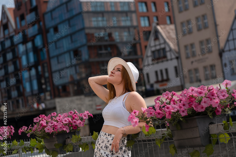 Fototapeta premium girl in a white hat on the background of the city of Gdansk Poland Europe