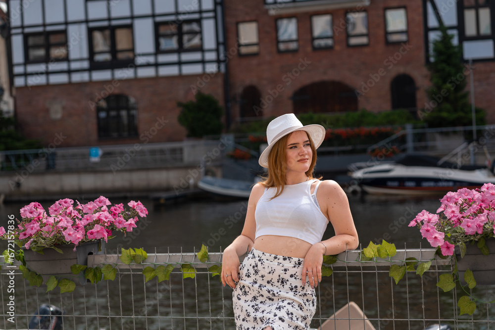 Obraz premium girl in a white hat on the background of the city of Gdansk Poland Europe