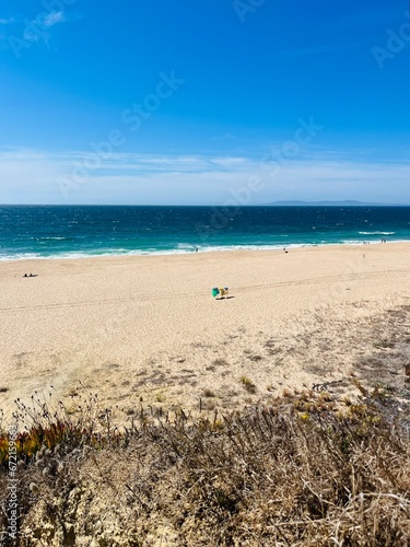 Sandy ocean bay with wild beach  blue ocean horizon
